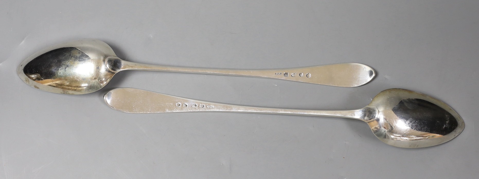 A pair of George III Scottish silver Celtic tip basting spoons, with engraved crest, Patrick Robertson, Edinburgh, 1790, 33.2cm, 7oz.